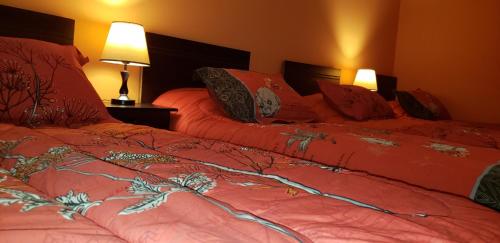 Postel nebo postele na pokoji v ubytování Hostal Nataly