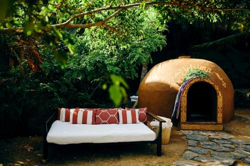 a couch sitting in front of a tent with a dog house at Cala de Mar Resort & Spa Ixtapa in Ixtapa