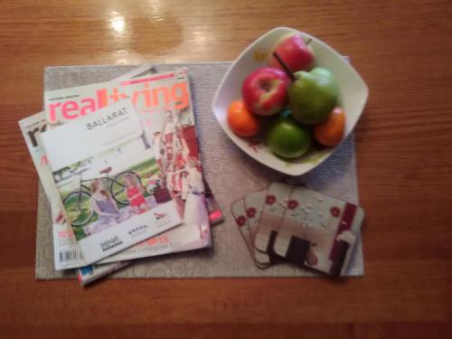 a bowl of fruit on a table with a magazine at Dunstans Guest House in Ballarat