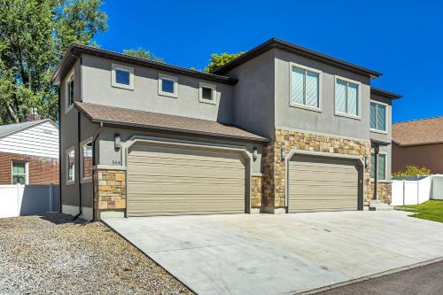 a house with two garage doors in a driveway at Spacious & New Guesthouse in Orem/Provo in Orem