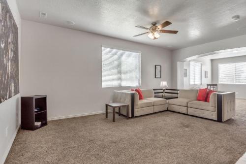 a living room with a couch and a ceiling fan at Spacious & New Guesthouse in Orem/Provo in Orem