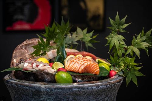 a bowl of food with fish and vegetables in it at Kensington Hotel Yeouido in Seoul