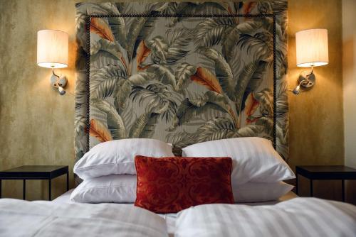 a bedroom with a bed with a headboard and two lamps at Statt Hassleholm BW Signature Collection in Hässleholm