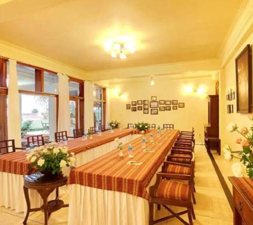 a large room with a long table and chairs at The Heritage Club - Tripura Castle Hotel and Spa in Shillong