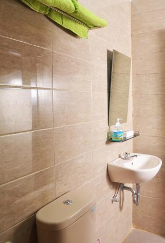a bathroom with a toilet and a sink at Cihampelas Homestay in Bandung