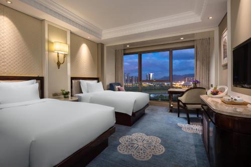 Postel nebo postele na pokoji v ubytování Kasion International Hotel Yiwu