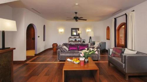 a living room with a couch and a table at Sanctum Inle Resort in Nyaung Shwe