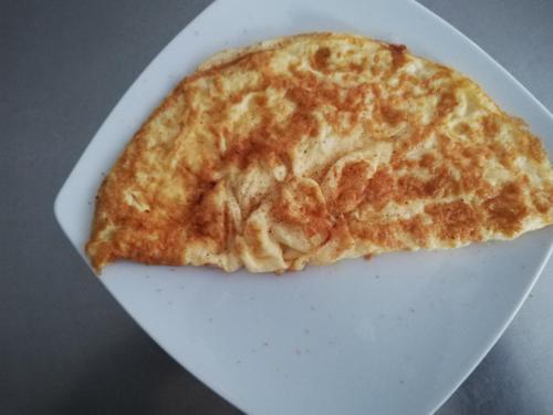 a slice of cheese pizza on a white plate at Vila Dorobantilor in Cluj-Napoca