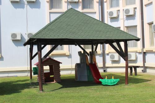 a gazebo with a slide and a playground at Hotel Prezident in Palić