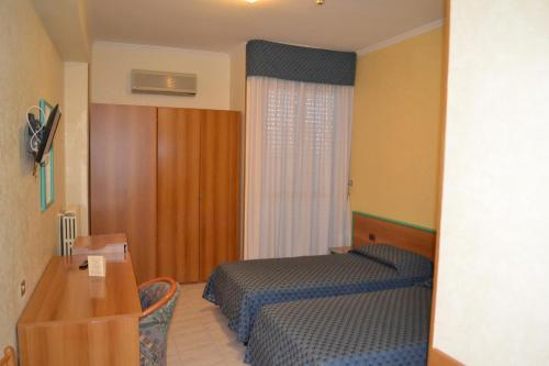 a hotel room with two beds and a mirror at La Villa dei Gourmets - Struttura Sanificata in Foggia
