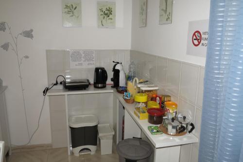 a small white kitchen with a counter top with food at BiancoCancello in Sacrofano