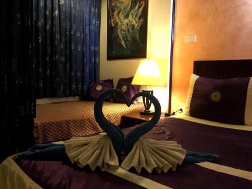 a sculpture of a swan on a bed in a hotel room at Casa E Mare in Kata Beach