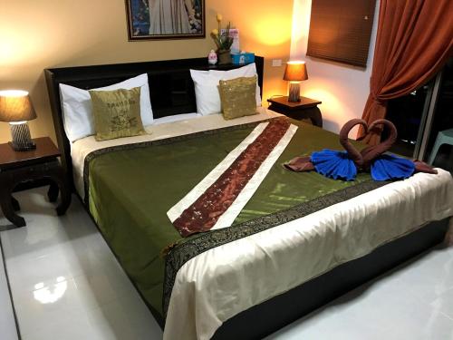 a bedroom with a large bed with towels on it at Casa E Mare in Kata Beach