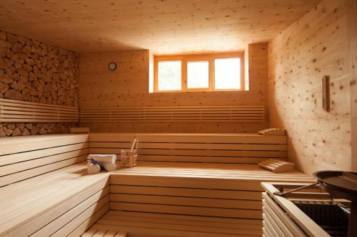 a sauna with wooden floors and a window at Hotel Schwaiger in Glonn