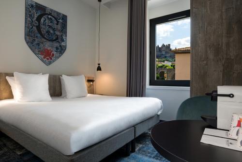 Postel nebo postele na pokoji v ubytování SOWELL HOTELS Les Chevaliers