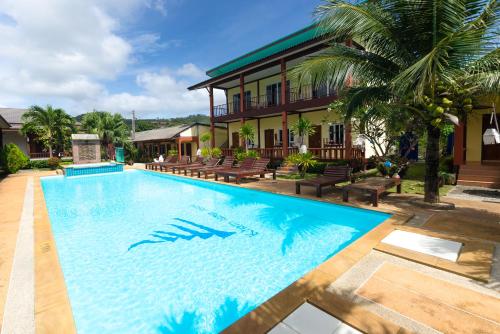a swimming pool in front of a house at Sleep In Lanta Resort in Ko Lanta