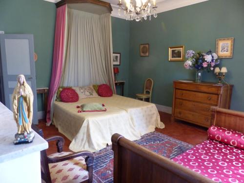 a bedroom with a bed with a cat laying on it at Château du Grand Jardin in Valensole
