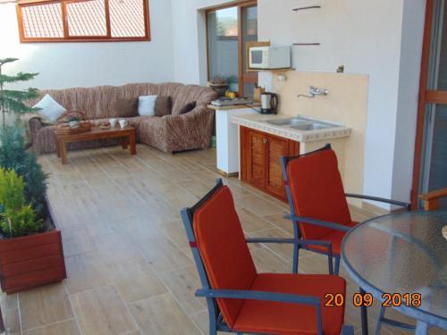 a living room with a couch and a table and chairs at Privat Alfa in Hrabušice