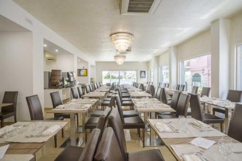 a row of tables and chairs in a restaurant at Casthotels Bristol Terme in Ischia