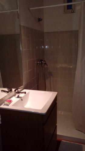 a bathroom with a sink and a shower at Casa do Forno, Viseu in Oliveira de Barreiros
