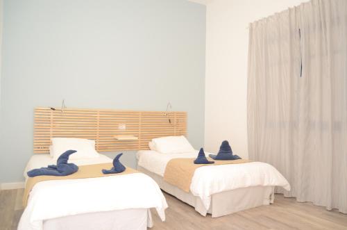 a bedroom with two beds with blue birds on them at Apartamentos El Marinero - Roque in Caleta de Sebo