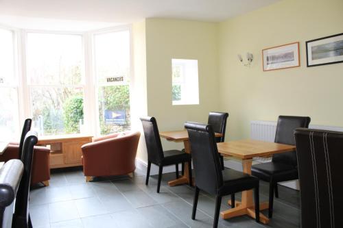 a dining room with a table and chairs at The Bay House Lake View Guest House - Adults Only in Bowness-on-Windermere