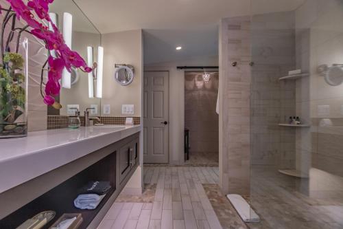 a bathroom with a walk in shower and a sink at Carriage House New Hope in New Hope