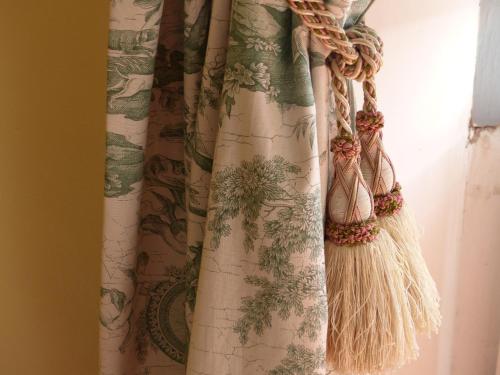 a curtain hanging in a room with a window at Château du Grand Jardin in Valensole