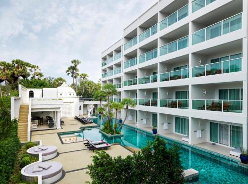 an image of a hotel with a swimming pool at Chanalai Romantica Resort - Adults Only, Kata Beach in Kata Beach