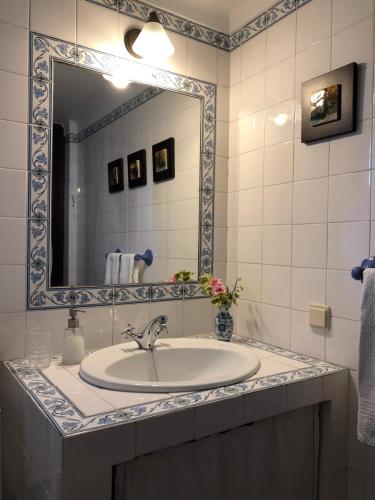 a bathroom with a sink and a mirror at Casas Dos Infantes - Turismo Rural in Caldas da Rainha