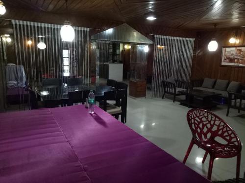 a purple table with a bottle of water on top of it at Hotel Kameng in Itānagar