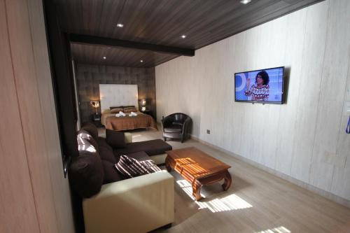 a living room with a couch and a bed at Hotel Copacabana Tarifa Beach in Tarifa