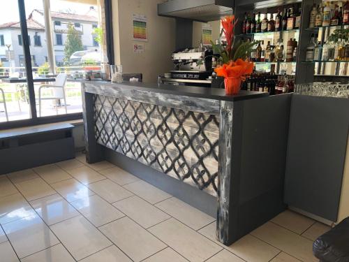 a bar in a restaurant with a counter at Park Hotel in Montecatini Terme