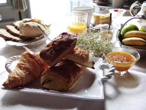 a plate of bread and pastries on a table at Château du Grand Jardin in Valensole