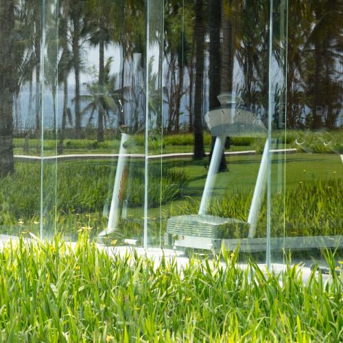 a glass window with a fountain in a park at Dialoog Banyuwangi in Banyuwangi
