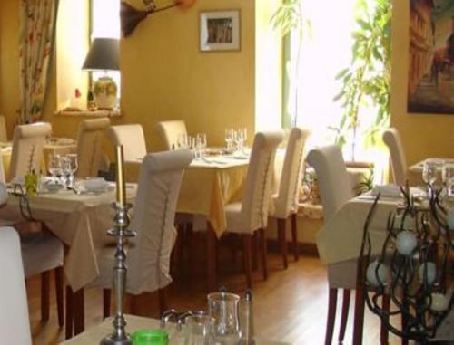 a dining room with white tables and chairs at Auberge de Marville in Marville