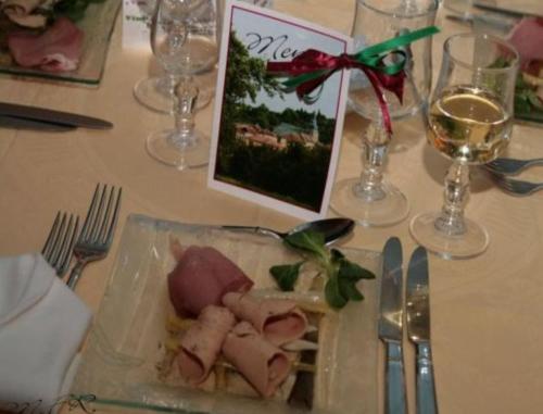 a plate of food on a table with wine glasses at Auberge de Marville in Marville