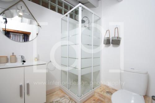 a bathroom with a shower with a toilet and a mirror at Casa Telégrafos in Jávea