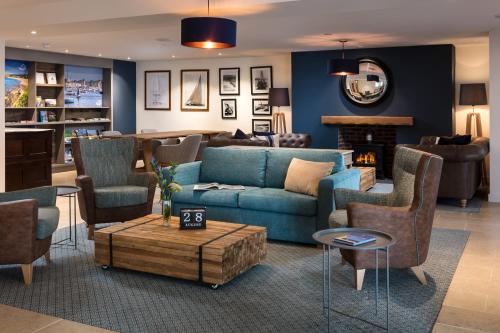 a living room with a blue couch and chairs at St Michaels Resort, Falmouth in Falmouth