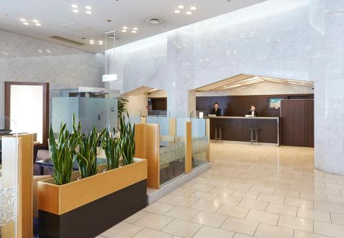 a lobby with a restaurant with plants in it at Miyako City Osaka Tennoji in Osaka