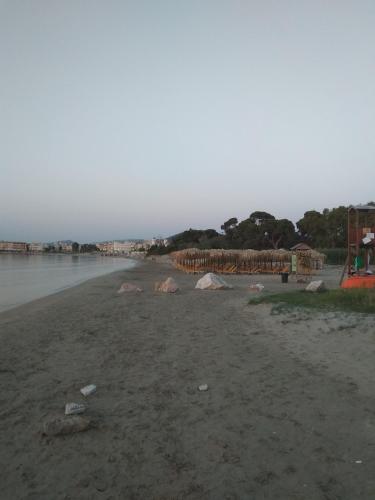 a beach with rocks on the shore of the water at Nina Rooms (apartments) in Artemida