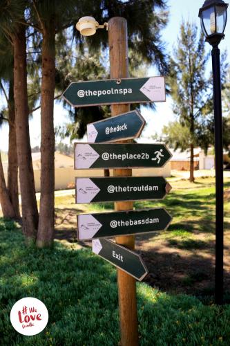 a street sign with arrows pointing in different directions at Lanseria Country Estate in Lanseria