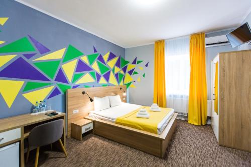 a bedroom with a bed with a colorful wall at Blum Hotel in Lviv
