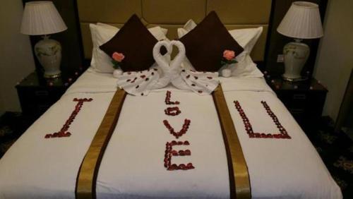 a wedding cake on a bed in a hotel room at Rest Night Serviced Apartments- AlHamra in Riyadh