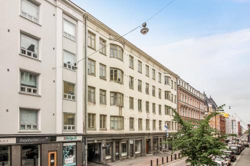 a large white building on a city street at Scandic Primo Apartments - Eerikinkatu 46m2 in Helsinki