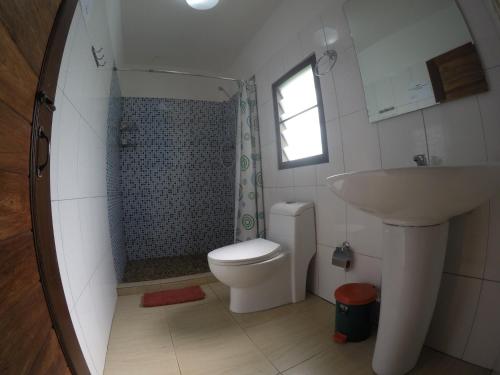 a bathroom with a shower and a toilet and a sink at Khao Sok Holiday Resort in Khao Sok National Park