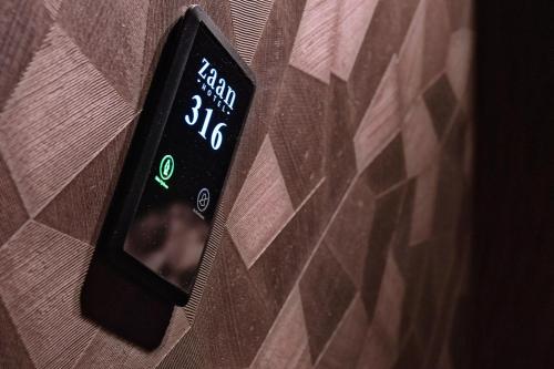 a remote control on a wall next to a brick wall at Zaan Hotel Amsterdam - Zaandam in Zaandam