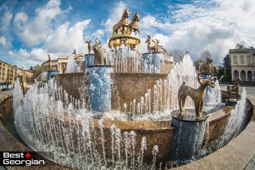 a water fountain in front of a building at AIA Apartment in Kutaisi