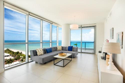 a living room filled with furniture and a view of the ocean at Monte Carlo by Miami Vacations in Miami Beach