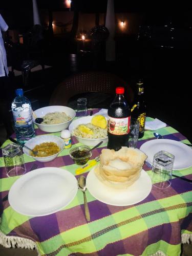 a table with plates of food on a table at White Villa Airport Transit Hotel in Katunayake